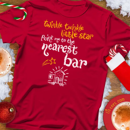 Red Christmas t-shirt with humorous text reading 'Twinkle Twinkle little star -  point me the nearest bar' and graphics on a festive background