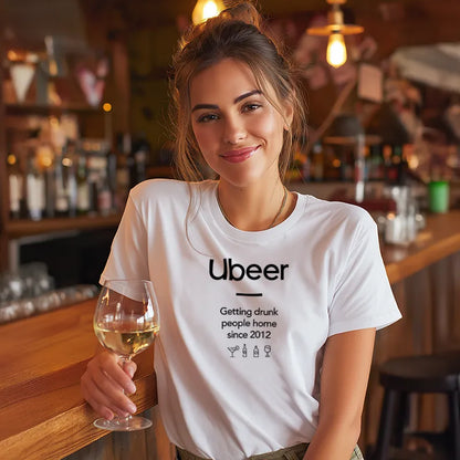 Woman in a bar wearing a white t-shirt with 'Ubeer' text, holding a glass of wine.